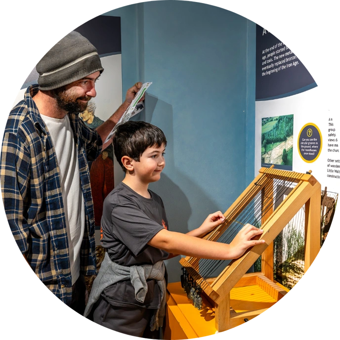 Man and boy looking at museum explainer board